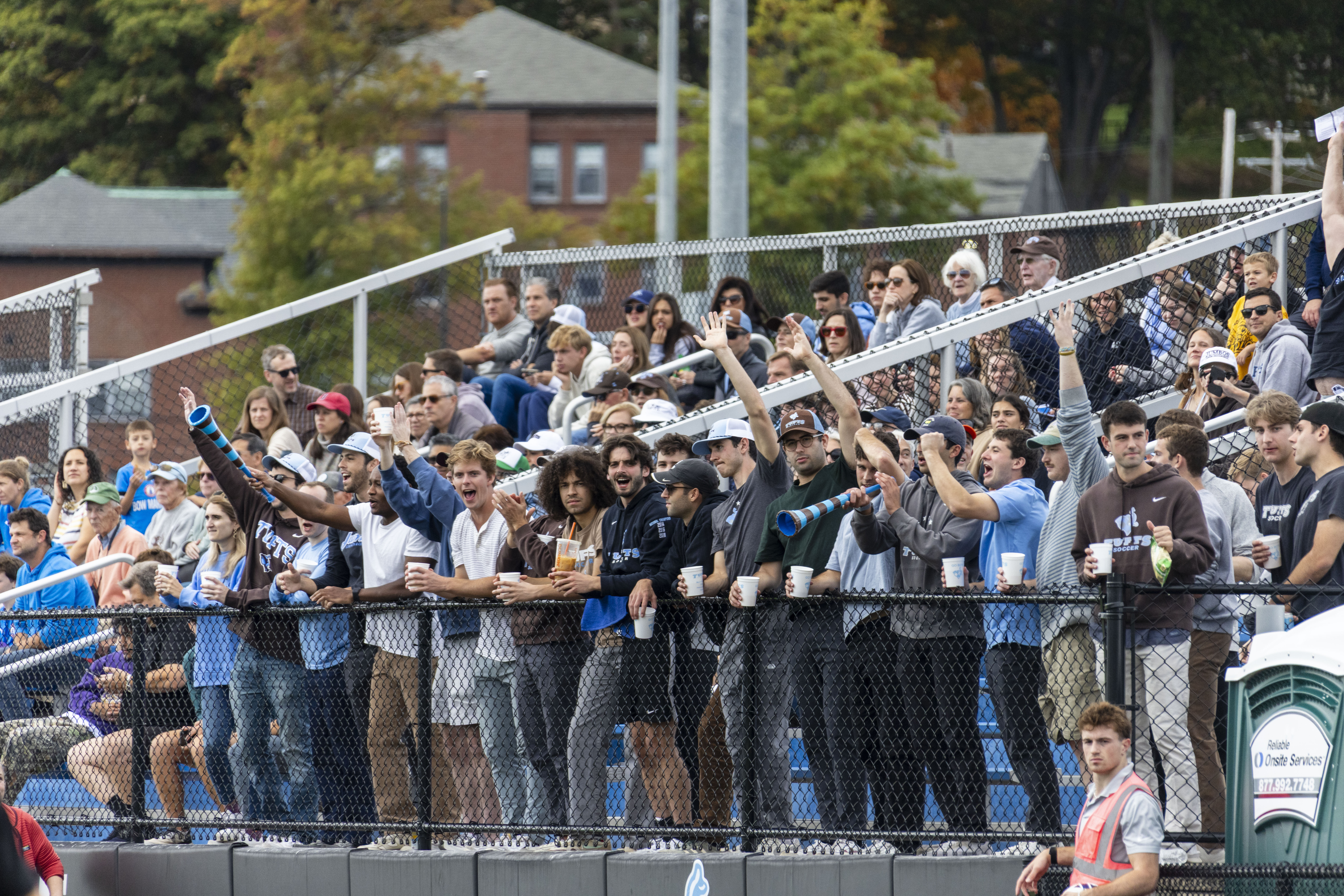 A crowd cheering on Men's Soccer team.